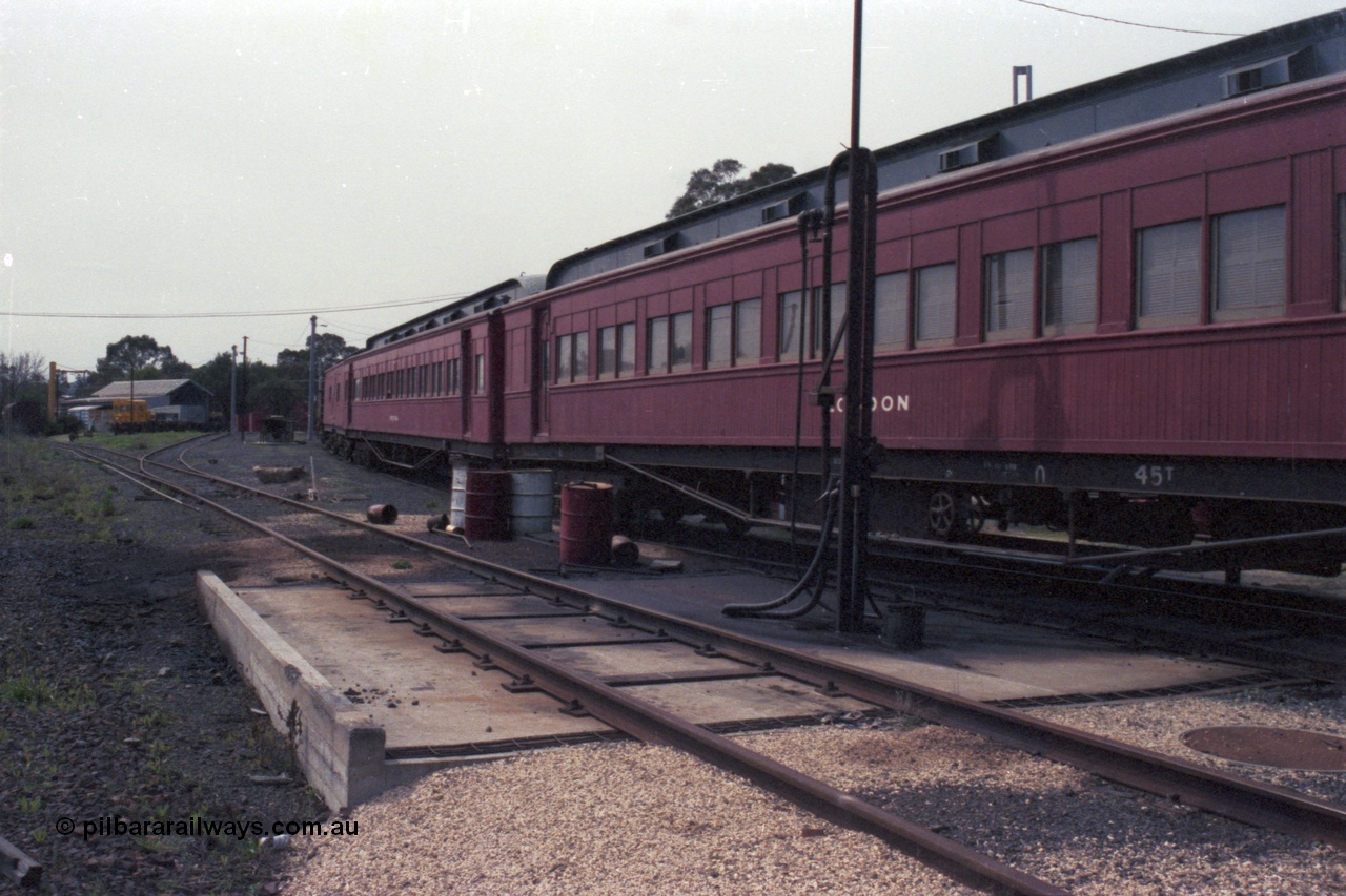 147-34
Seymour loco depot, stabled train, former Joint Stock Sleeper, No.10 Sleeper 'LODDON' at the fuel point, originally built in 1907 and called 'MELBOURNE', renamed in 1910, removed from Joint Stock in 1969 and named No. 10, then around 1984 renamed 'LODDON' in 'Train of Knowledge' service, with another Joint Stock Sleeper 'Pekina' and what looks like 'Carey'. This would no doubt be the 'Train of Knowledge'.
Keywords: E-class;Loddon;Victorian-Railways-Newport-WS;Joint-Stock;Melbourne-Sleeper;