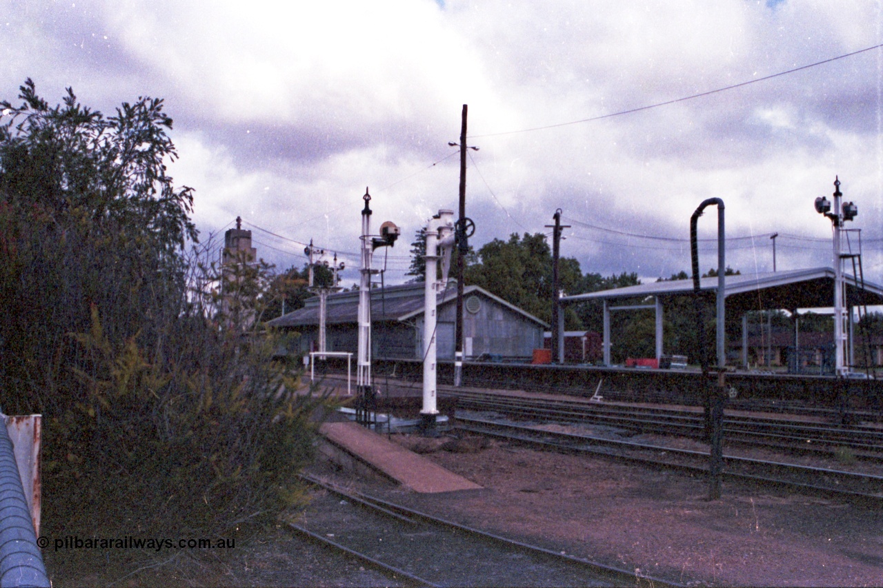 148-03
Wangaratta, view of disc signal post 18 for Siding A to Main Line, old and new water standpipes and twin disc signal post 19, goods shed and platform with 'Freight Gate' canopy in the background.
