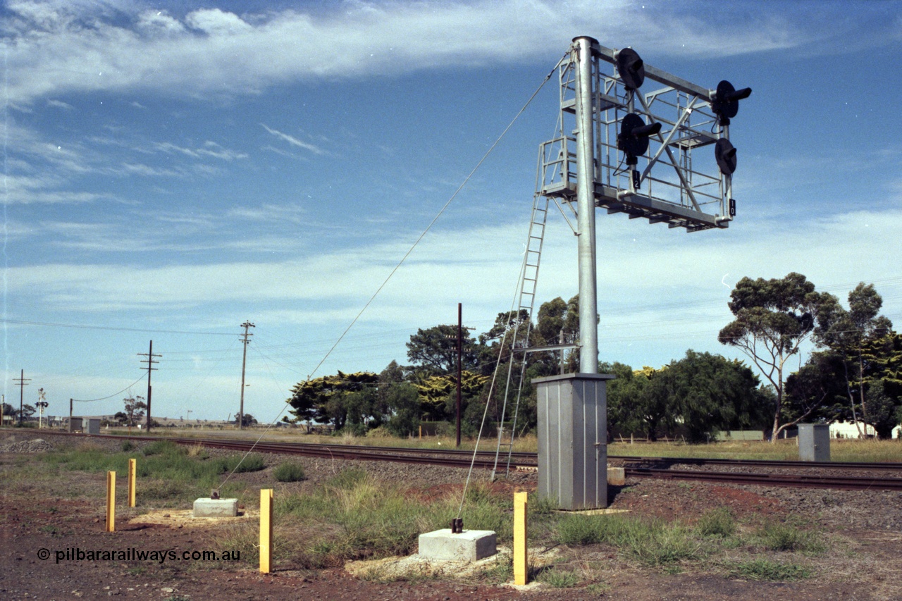 149-05
Rockbank, view of cantilevered signal post with searchlight signals 12 (No. 2 Road) and 10 (No. 1 Road) Up Home Signals, train control telephone booth and wire stays in foreground.
