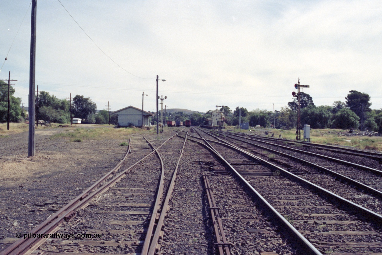 149-12
Bacchus Marsh yard overview from Melbourne end point rodding and signals, goods shed at left, stabled passenger sets, station, with road to turntable branching off to the right.
