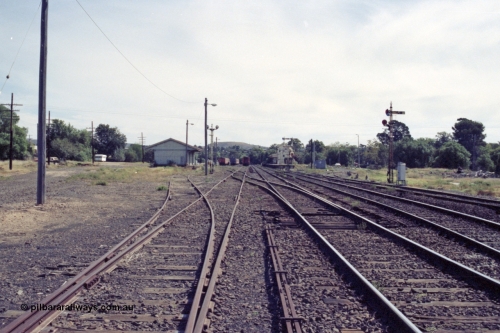 149-12
Bacchus Marsh yard overview from Melbourne end point rodding and signals, goods shed at left, stabled passenger sets, station, with road to turntable branching off to the right.

