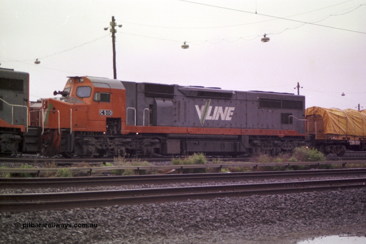 150-02
Tottenham yard, V/Line broad gauge C class loco C 510 Clyde Engineering EMD model GT26C serial 76-833 is 2nd unit on Adelaide bound goods train 9169 in rain as departure time approaches, side view.
Keywords: C-class;C510;Clyde-Engineering-Rosewater-SA;EMD;GT26C;76-833;