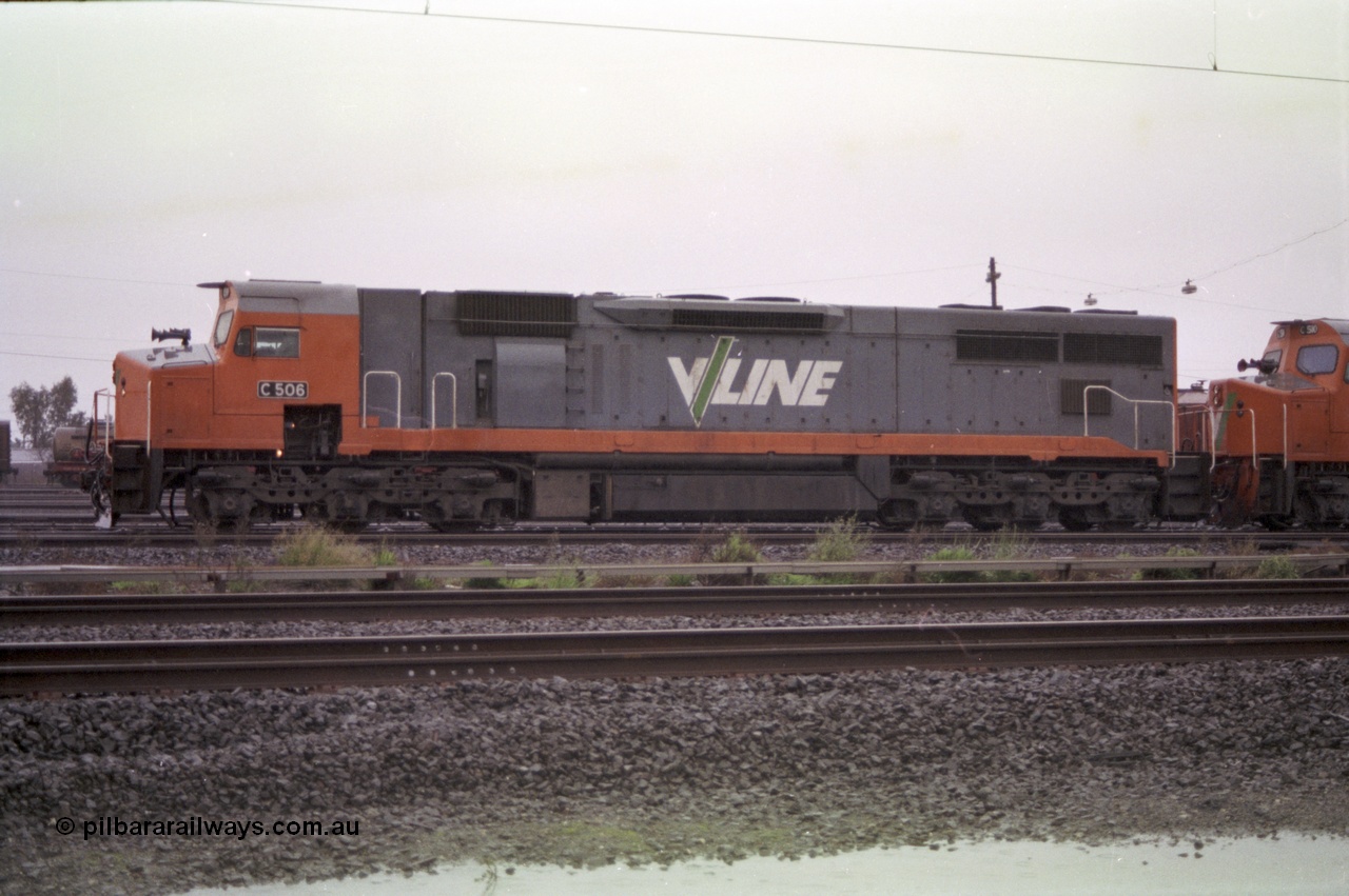 150-03
Tottenham yard, V/Line broad gauge C class loco C 506 Clyde Engineering EMD model GT26C serial 76-829 heads up Adelaide bound goods train 9169 in rain as departure time approaches, side view.
Keywords: C-class;C506;Clyde-Engineering-Rosewater-SA;EMD;GT26C;76-829;