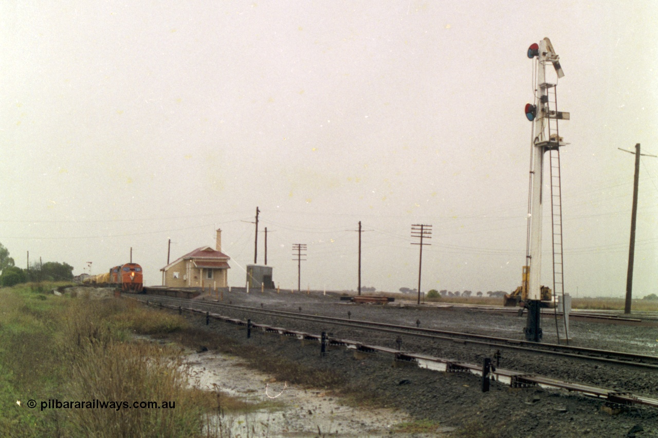 150-09
Gheringhap, station overview, point rodding and interlocking, semaphore signal post four pulled off for train 9169 to depart on the Maroona line, broad gauge V/Line C classes Clyde Engineering EMD model GT26C on the lead.
