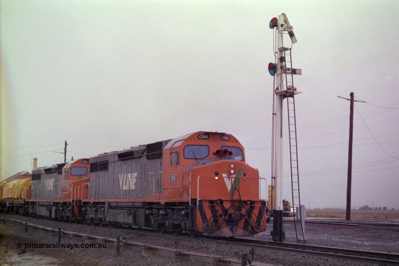 150-10
Gheringhap, broad gauge V/Line C class locos C 506 Clyde Engineering EMD model GT26C serial 76-829 and C 510 serial 76-833 lead down Adelaide goods train 9169 onto the Maroona line past semaphore signal post No.4, point rodding and signal wires in foreground.
Keywords: C-class;C506;Clyde-Engineering-Rosewater-SA;EMD;GT26C;76-829;