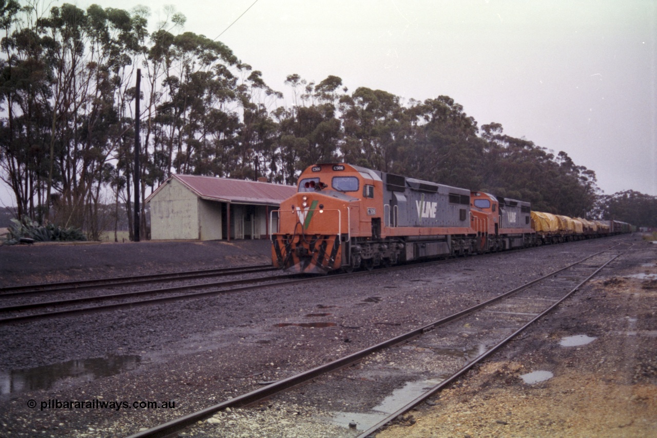 150-16
Lismore, station yard and building, looking towards Melbourne from goods loading ramp, V/Line broad gauge C classes C 506 Clyde Engineering EMD model GT26C serial 76-829 and C 510 serial 76-833 leading Adelaide bound goods train 9169 along No. 2 road past the station building, the goods loop or No. 3 road is closest to camera.
Keywords: C-class;C506;Clyde-Engineering-Rosewater-SA;EMD;GT26C;76-829;