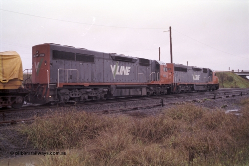 150-11
Gheringhap, broad gauge V/Line C class locos C 506 Clyde Engineering EMD model GT26C serial 76-829 and C 510 serial 76-833 lead down Adelaide goods train 9169 onto the Maroona line, point rodding and signal wires in foreground, trailing view.
Keywords: C-class;C510;Clyde-Engineering-Rosewater-SA;EMD;GT26C;76-833;
