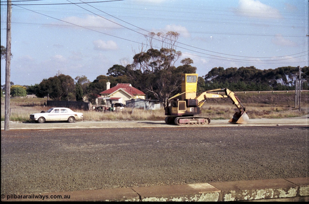 151-11
Gheringhap, view across yard from station platform looking at unloading contraption for extracting gypsum out of open waggons, and my HK Holden, the little four pane window is the start of the Gheringhap Loop train sightings page.
