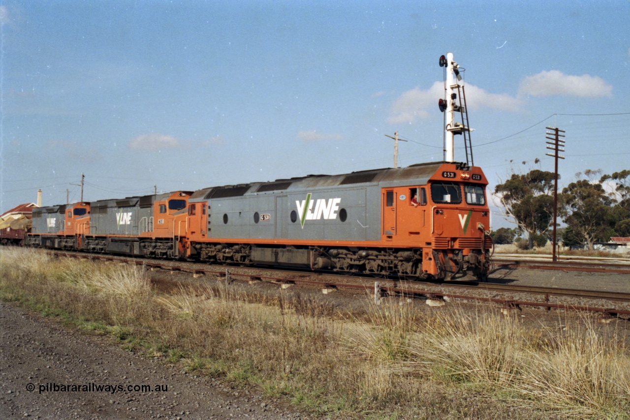 151-16
Gheringhap, broad gauge V/Line Adelaide bound goods train 9169 on No.1 Road under the power of G class G 531 Clyde Engineering EMD model JT26C-2SS serial 88-1261, C class C 510 Clyde Engineering EMD model GT26C serial 76-833 and C 509 serial 76-832 depart with signal post four set for the Maroona line, point rodding and signal wires in foreground.
Keywords: G-class;G531;Clyde-Engineering-Somerton-Victoria;EMD;JT26C-2SS;88-1261;