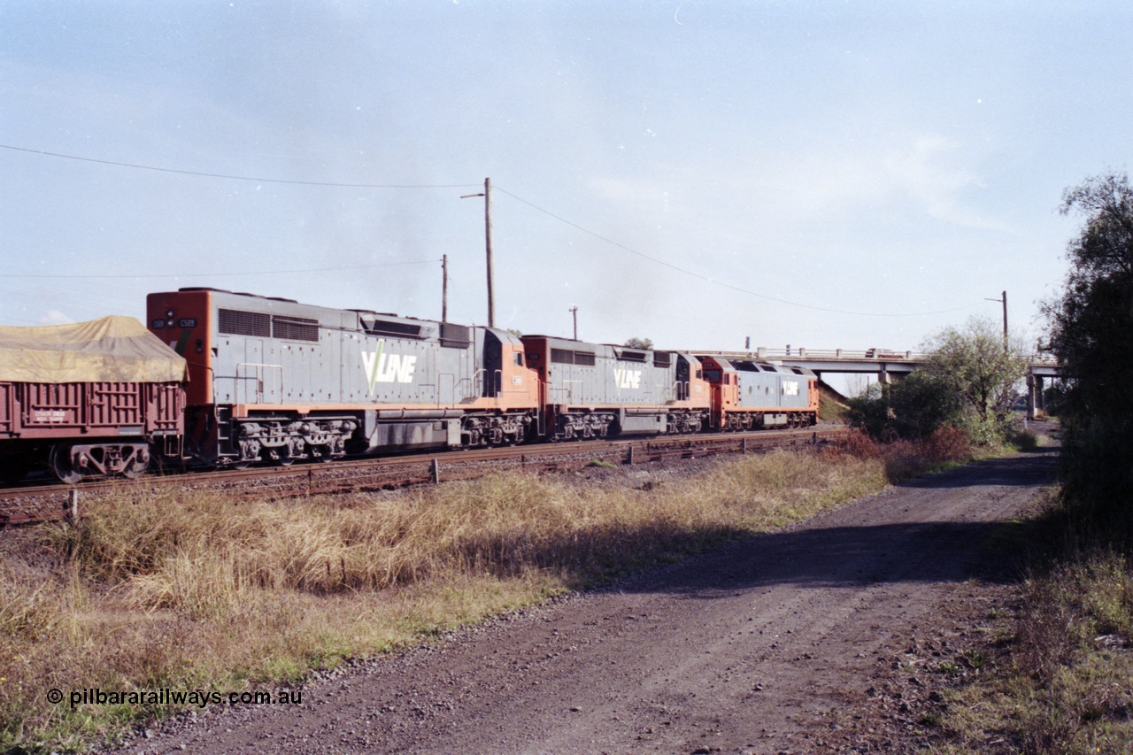 151-17
Gheringhap, broad gauge V/Line Adelaide bound goods train 9169 on No.1 Road under the power of G class G 531 Clyde Engineering EMD model JT26C-2SS serial 88-1261, C class C 510 Clyde Engineering EMD model GT26C serial 76-833 and C 509 serial 76-832 on the Maroona line, point rodding and signal wires in foreground, trailing view.
Keywords: C-class;C509;Clyde-Engineering-Rosewater-SA;EMD;GT26C;76-832;