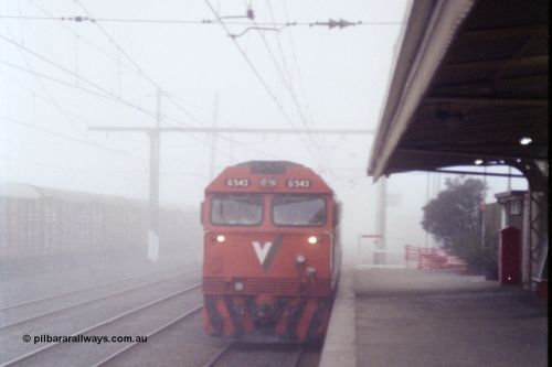 151-24
Traralgon station platform, V/Line broad gauge G class G 543 Clyde Engineering EMD model JT26C-2SS serial 89-1276 light engine with an X class awaits departure time on 9444 light engine to Morwell and then loaded briquette train to Nth Geelong in heavy fog.
Keywords: G-class;G543;Clyde-Engineering-Somerton-Victoria;EMD;JT26C-2SS;89-1276;
