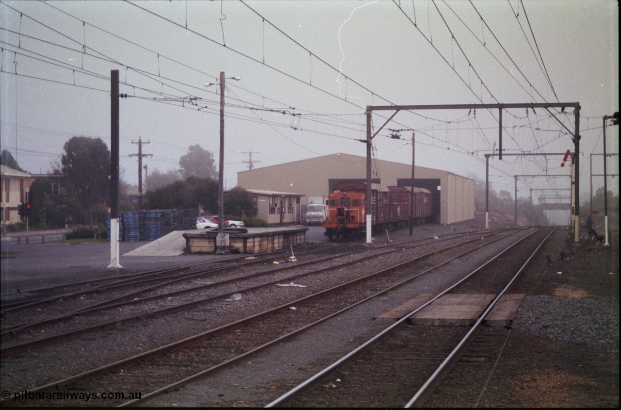 152-05
Morwell yard view looking towards Melbourne, signal post seven pulled off for up passenger train, V/Line rail tractor RT class RT 51 at the Freightgate goods shed with various louvre van, loading platform. RT 51 was converted in 1959 from the underframe of I type I 7257 built in September 1904, in 1935 recoded IA.
