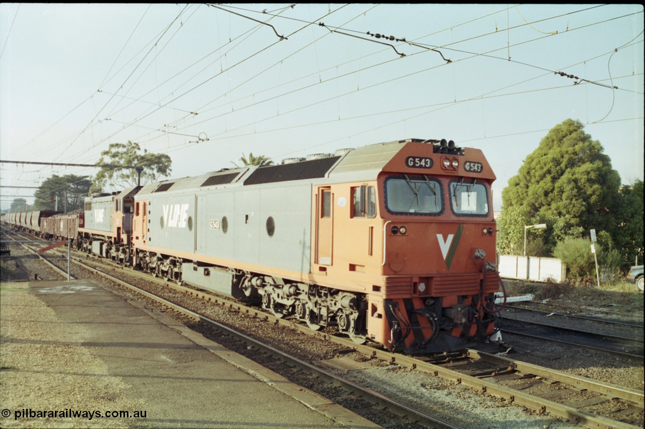 152-09
Morwell station yard, V/Line broad gauge train 9444 goods to Nth Geelong arrives into the yard from the briquette sidings behind G class G 543 Clyde Engineering EMD model JT26C-2SS serial 89-1276 and X class X 43 Clyde Engineering EMD model G26C serial 70-706, taken from station platform.
Keywords: G-class;G543;Clyde-Engineering-Somerton-Victoria;EMD;JT26C-2SS;89-1276;