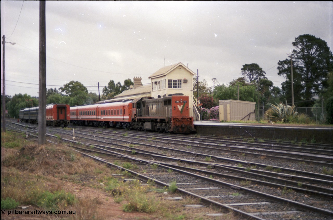 153-1-02
Bacchus Marsh, station yard overview, V/Line broad gauge loco X class X 42 Clyde Engineering EMD model G26C serial 70-705 long end leading and N set with an up passenger service for Melbourne, station platform, elevated signal box, platform shed, stabled pass consist in yard.
Keywords: X-class;X42;Clyde-Engineering-Granville-NSW;EMD;G26C;70-705;