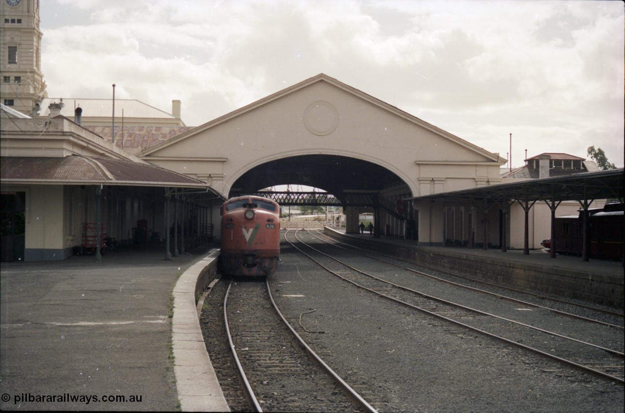 153-1-13
Ballarat station building, platform and yard overview looking from the east end of the platform and through canopy, broad gauge V/Line A class A 79 Clyde Engineering EMD model AAT22C-2R serial 84-1188 rebuilt from B 79 Clyde Engineering EMD model ML2 serial ML2-20 at platform.
Keywords: A-class;A79;Clyde-Engineering-Rosewater-SA;EMD;AAT22C-2R;84-1188;rebuild;bulldog;