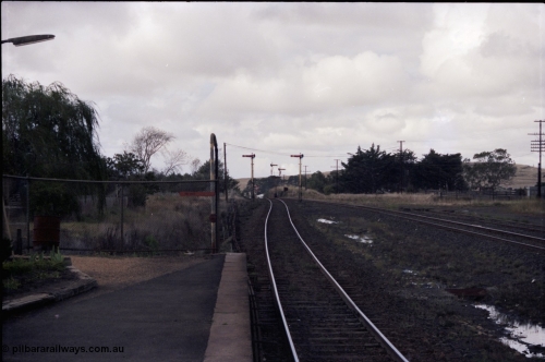 153-1-06
Ballan yard view looking towards Melbourne from station platform, semaphore signal posts 3 and 4 for up departure moves and semaphore signal post 2 down home, searchlight signal post 7? In the background, stand pipe at end of platform and stockyards at right.
