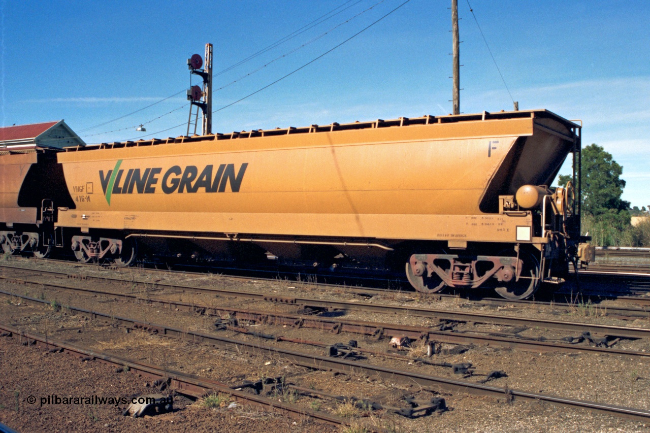153-2-15
Ballarat station yard, broad gauge V/Line Grain VHGF type bogie grain hopper waggon VHGF 416 originally built by V/Line's Ballarat North Workshops in November 1984 as VHGY type and recoded in 1988 to VHGF, view from handbrake end, double disc signal mast behind, catch point interlocking and rodding in foreground.
Keywords: VHGF-type;VHGF416;V/Line-Ballarat-Nth-WS;VHGY-type;