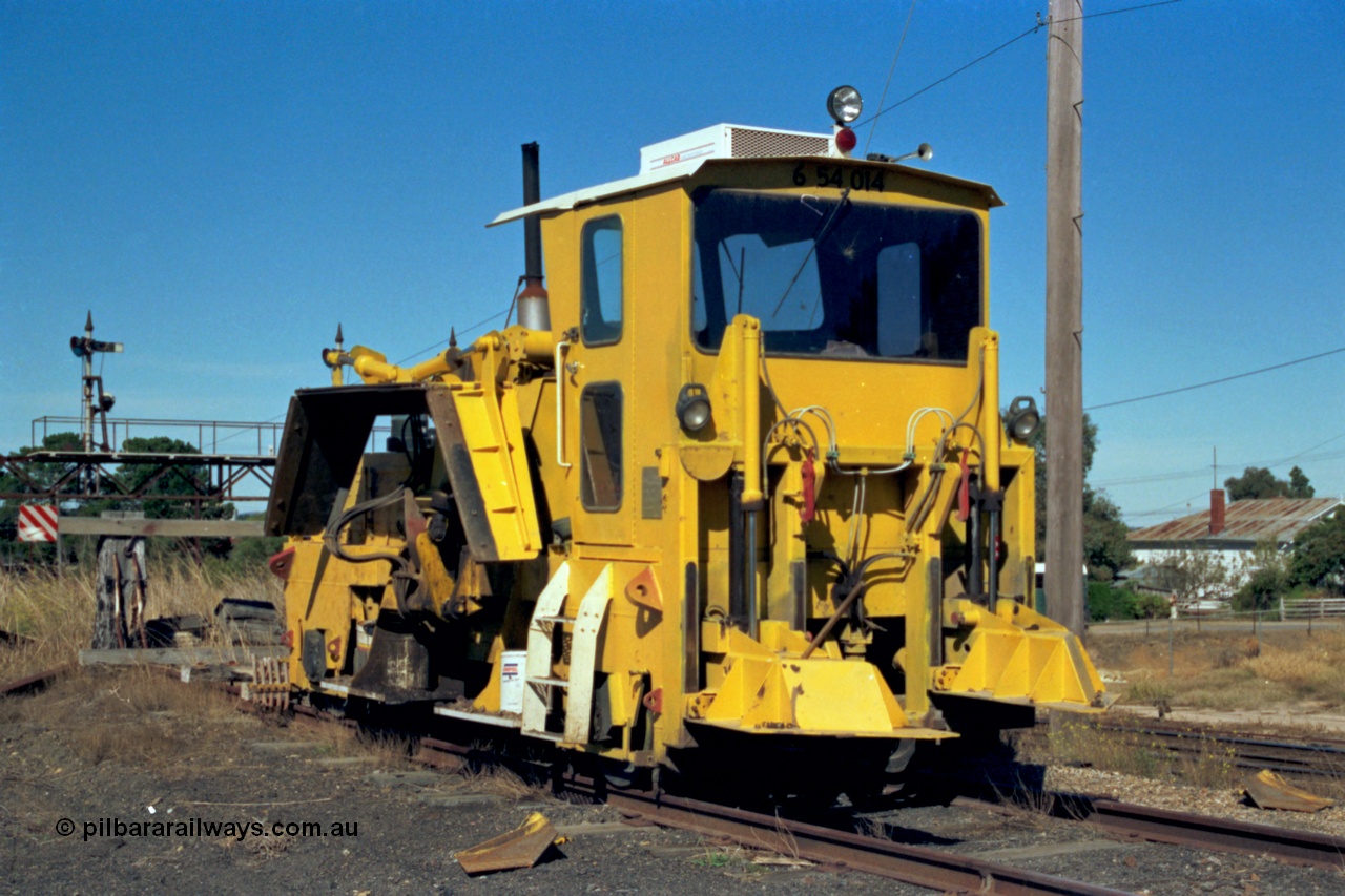 153-2-36
Ararat station yard, ballast regulator, signal gantry for mainline behind in background.
