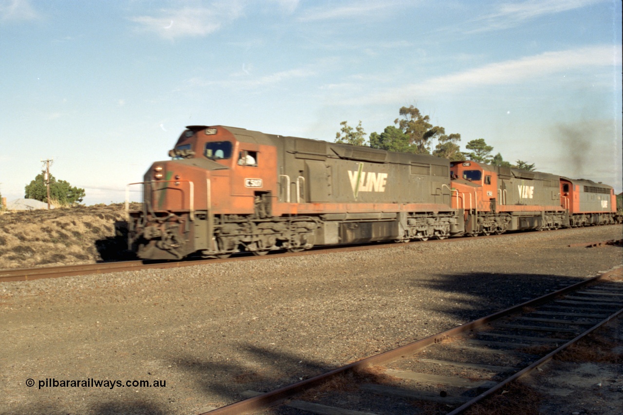 153-3-12
Mininera, the peace is shattered as V/Line broad gauge goods to Adelaide train 9169 is lead by C class C 507 Clyde Engineering EMD model GT26C serial 76-830, C 502 serial 76-825 and an S class, bit out of focus as it caught the photographer by surprise.
Keywords: C-class;C507;Clyde-Engineering-Rosewater-SA;EMD;GT26C;76-830;