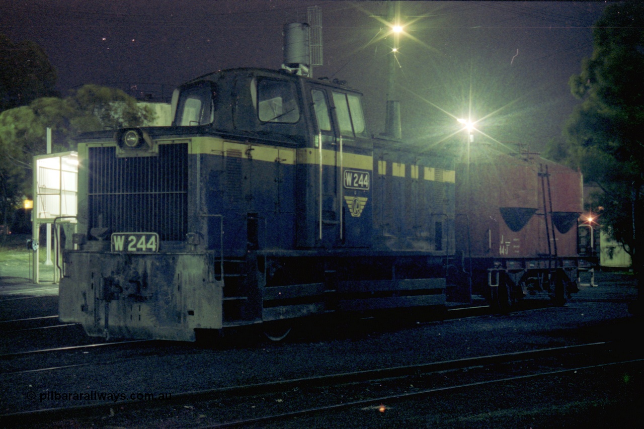 153-3-31
Geelong loco depot, stabled broad gauge Geelong shunt engine W class W 244 Tulloch Ltd model 1-MS 0-6-0 diesel hydraulic serial 9 still in Victorian Railways blue and gold livery, and J type four wheel sand waggon J 44, night shot.
Keywords: W-class;W244;Tulloch-Ltd-NSW;1-MS;9;