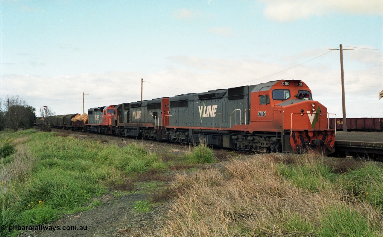 154-03
Gheringhap, V/line broad gauge goods train 9169 to Adelaide, via Cressy pauses at the station platform, triple C class locos leading, C 510 Clyde Engineering EMD model GT26C serial 76-833 leads C 508 serial 76-831 and C class leader C 501 'George Brown' serial 76-824, VOJF type bogie gypsum waggon in background, taken from former No.2 platform.
Keywords: C-class;C510;Clyde-Engineering-Rosewater-SA;EMD;GT26C;76-833;