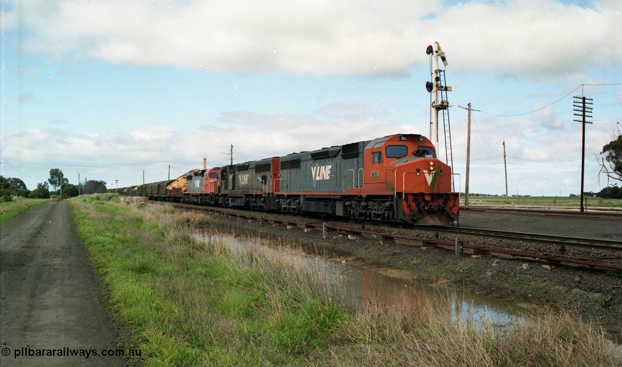 154-06
Gheringhap, V/Line broad gauge goods train 9169 departs past timber semaphore signal post 4 for the Maroona line with C class C 510 Clyde Engineering EMD model GT26C serial 76-833, C 508 serial 76-831 and C class leader C 501 'George Brown' serial 76-824, point rodding and signal wires in the foreground with the yard and station behind the train, former No.2 platform visible on the left hand side background.
Keywords: C-class;C510;Clyde-Engineering-Rosewater-SA;EMD;GT26C;76-833;