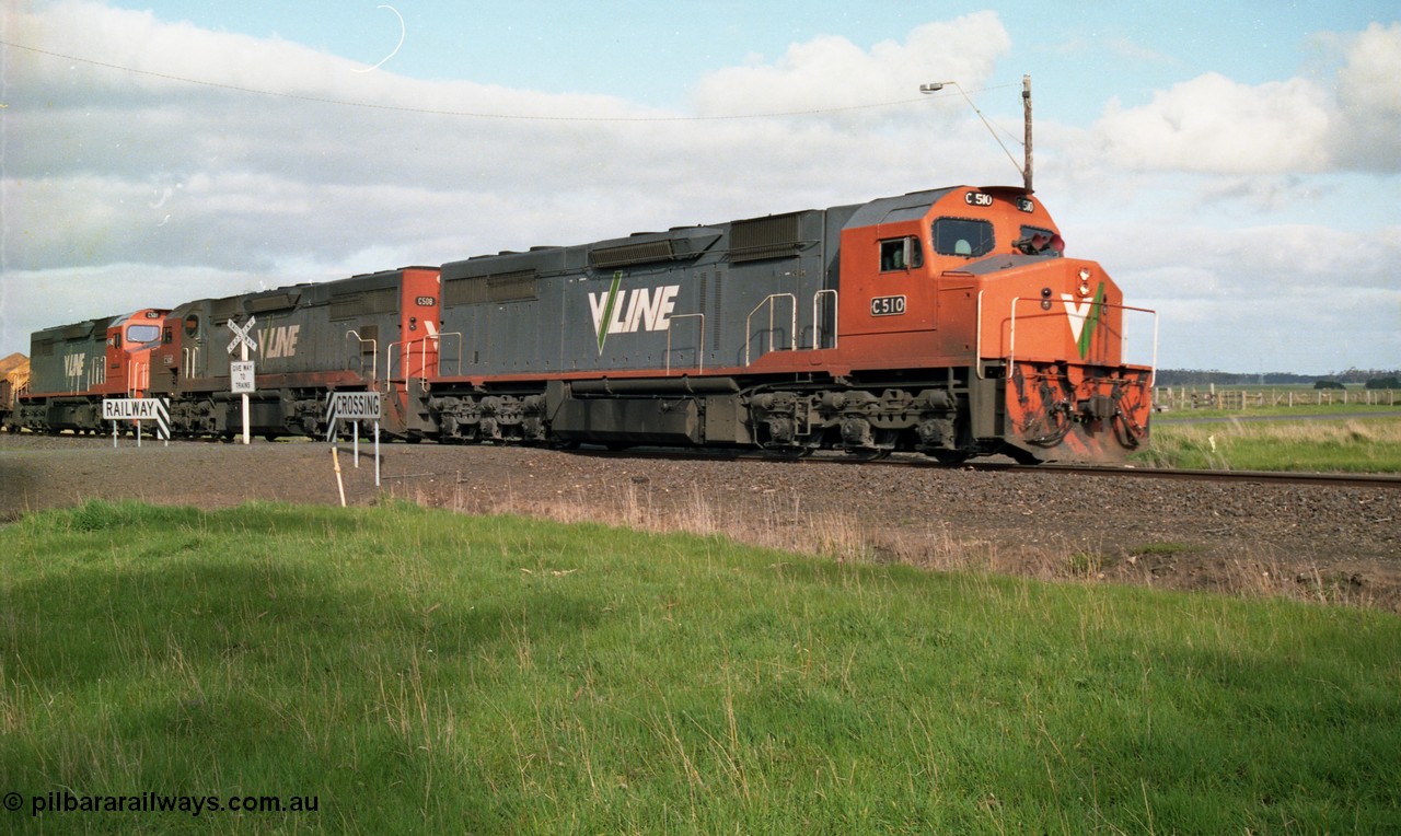 154-10
Lismore, V/Line broad gauge C class locomotives C 510 Clyde Engineering EMD model GT26C serial 76-833, C 508 serial 76-831 and C class leader C 501 'George Brown' serial 76-824 cross Gnarpurt Road with Adelaide bound goods train 9169.
Keywords: C-class;C510;Clyde-Engineering-Rosewater-SA;EMD;GT26C;76-833;