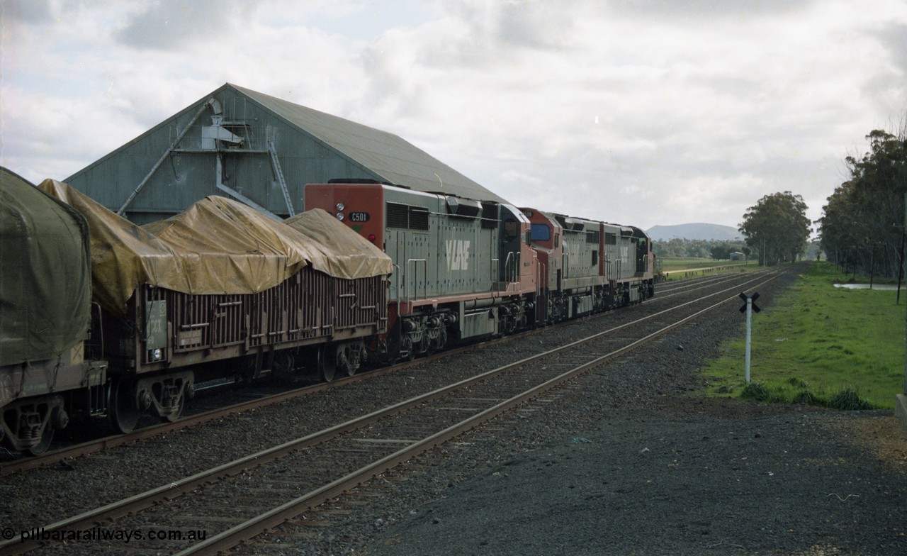 154-22
Lismore, V/Line broad gauge C class C 510 Clyde Engineering EMD model GT26C serial 76-833, C 508 serial 76-831 and C class leader C 501 'George Brown' serial 76-824, with VCCX type bogie open steel transport waggon VCCX 6, lead the Adelaide bound goods train 9169 past the grain bunker on No.3 Rd, train is on No.2 Rd as the unattended crossing loops utilise left hand lay trailable points.
Keywords: C-class;C501;Clyde-Engineering-Rosewater-SA;EMD;GT26C;76-824;