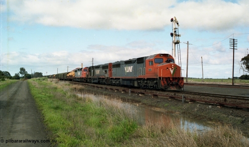154-06
Gheringhap, V/Line broad gauge goods train 9169 departs past timber semaphore signal post 4 for the Maroona line with C class C 510 Clyde Engineering EMD model GT26C serial 76-833, C 508 serial 76-831 and C class leader C 501 'George Brown' serial 76-824, point rodding and signal wires in the foreground with the yard and station behind the train, former No.2 platform visible on the left hand side background.
Keywords: C-class;C510;Clyde-Engineering-Rosewater-SA;EMD;GT26C;76-833;