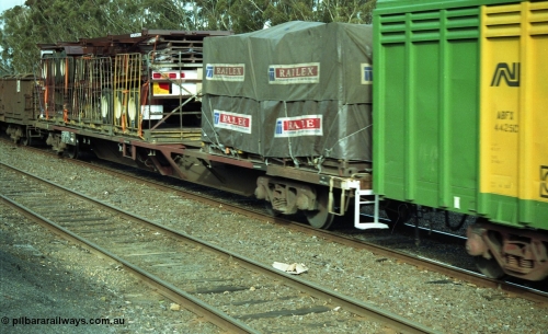 154-23
Lismore, V/Line broad gauge bogie 60 foot container flat waggon with FCL skel trailers on board.

