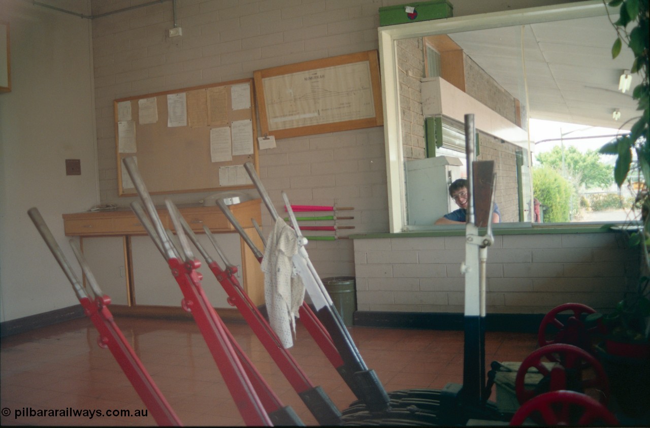 156-23
Numurkah, station building, internal view of lever frame, signal levers and diagram on wall, taken through window.
