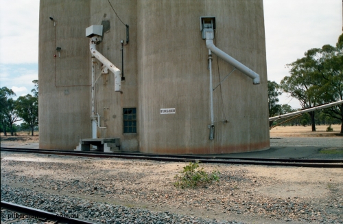 156-21
Wunghnu, station name painted on Williamstown style silos, train out loading spouts.
