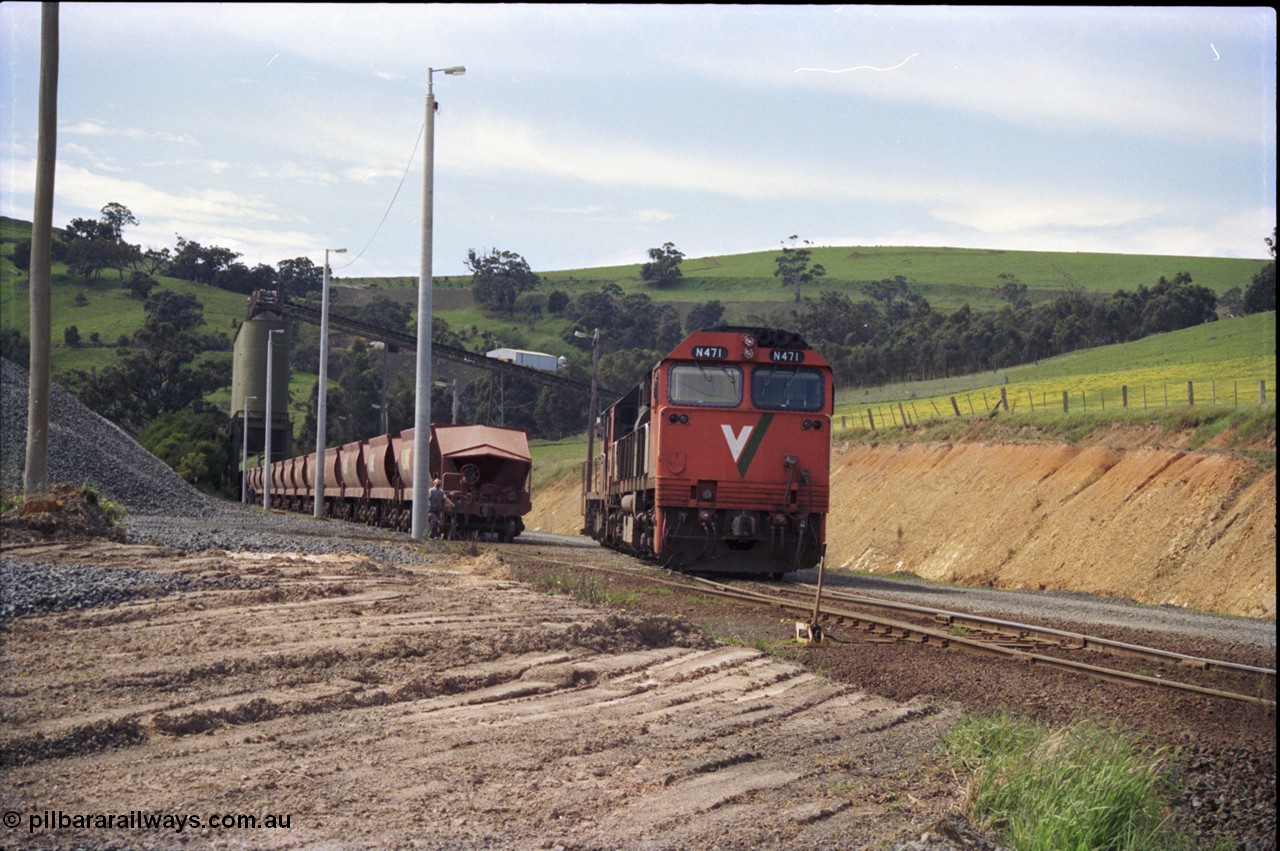 157-08
Kilmore East, Apex Quarry Siding, V/Line broad gauge locomotives N class N 471 'City of Benalla' Clyde Engineering EMD model JT22HC-2 serial 87-1200 and T class T 390 Clyde Engineering EMD model G8B serial 65-420 shunt round their train as the driver leans out the window of the T class, second person is walking up beside waggons, the locos will run through the points.
Keywords: N-class;N471;Clyde-Engineering-Somerton-Victoria;EMD;JT22HC-2;87-1200;