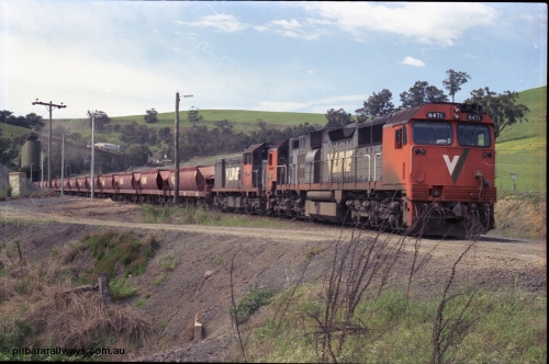 157-29
Kilmore East, Apex Quarry Siding, V/Line broad gauge locomotives N class N 471 'City of Benalla' Clyde Engineering EMD model JT22HC-2 serial 87-1200 and T class T 390 Clyde Engineering EMD model G8B serial 65-420 with train under the loading bins during loading operations, view from Broadford - Kilmore Road.
Keywords: N-class;N471;Clyde-Engineering-Somerton-Victoria;EMD;JT22HC-2;87-1200;