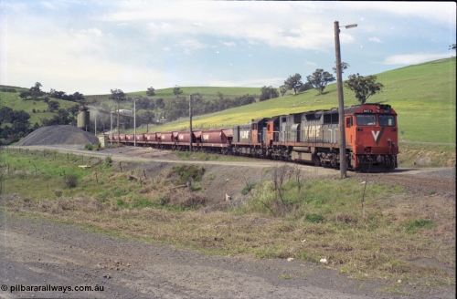 157-30
Kilmore East, Apex Quarry Siding, V/Line broad gauge locomotives N class N 471 'City of Benalla' Clyde Engineering EMD model JT22HC-2 serial 87-1200 and T class T 390 Clyde Engineering EMD model G8B serial 65-420 with train under the loading bins during loading operations, view from Broadford - Kilmore Road.
Keywords: N-class;N471;Clyde-Engineering-Somerton-Victoria;EMD;JT22HC-2;87-1200;
