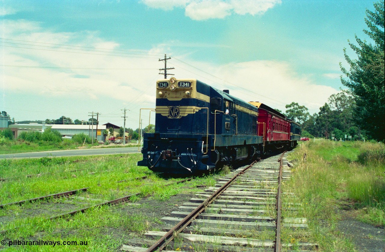 158-04
Healesville, Yarra Valley Tourist Railway operations, overgrown yard view looking towards Yarra Glen, train arriving in yard behind former Victorian Railways T class T 341 Clyde Engineering EMD model G8B serial 56-120 still in Victorian Railways livery with a carriage and DERM 52 RM, also in Victorian Railways livery.
Keywords: T-class;T341;Clyde-Engineering-Granville-NSW;EMD;G8B;56-120;