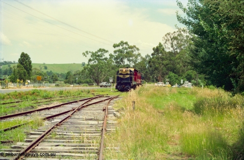 158-03
Healesville, Yarra Valley Tourist Railway operations, overgrown yard view looking towards Yarra Glen, train on grade crossing entering yard behind former Victorian Railways T class T 341 Clyde Engineering EMD model G8B serial 56-120 still in Victorian Railways livery.
Keywords: T-class;T341;Clyde-Engineering-Granville-NSW;EMD;G8B;56-120;