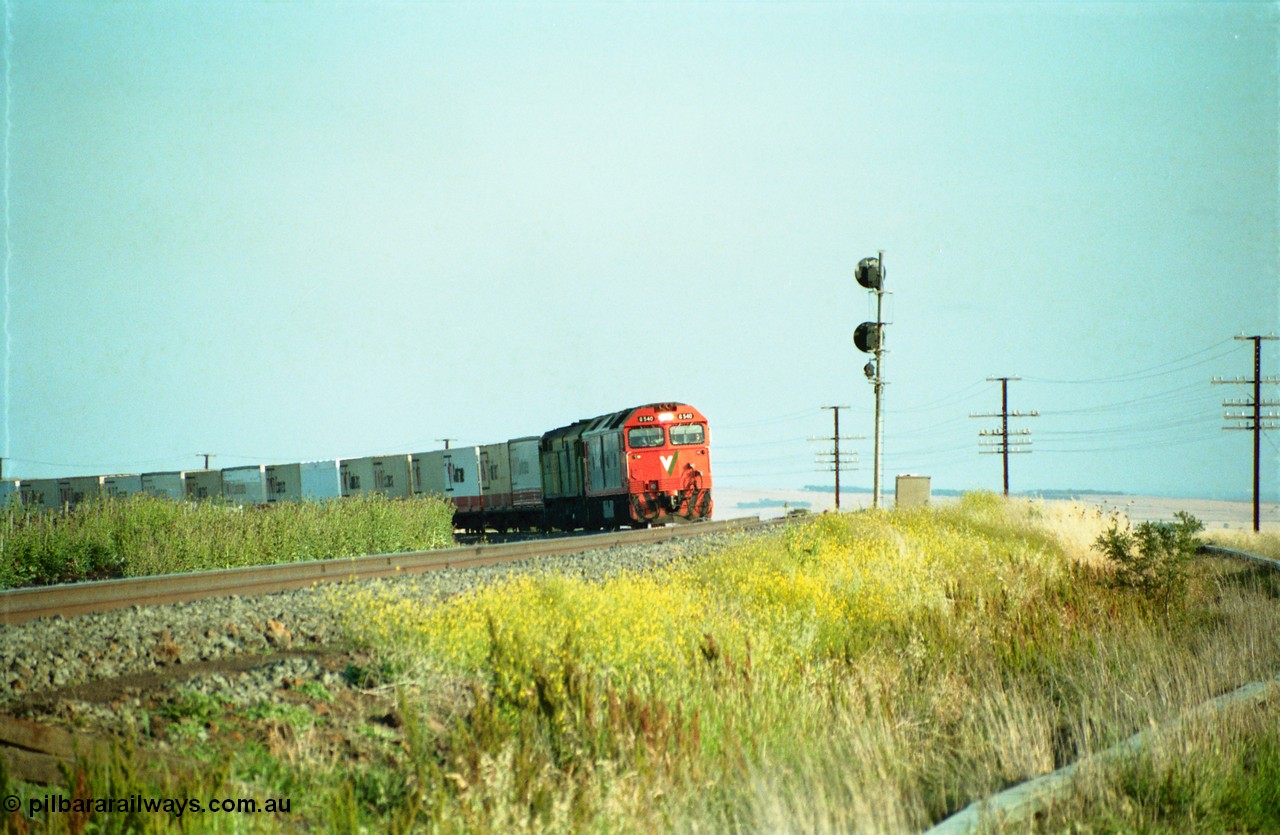 159-04
Bank Box Loop, distant view of a down Adelaide bound broad gauge goods train rounding the curve with the super elevation of the mainline visible being hauled by V/Line G class G 540 Clyde Engineering EMD model JT26C-2SS serial 89-1273 and Australian National 700 class 704 AE Goodwin ALCo model DL500G serial G6059-2.
Keywords: G-class;G540;Clyde-Engineering-Somerton-Victoria;EMD;JT26C-2SS;89-1273;