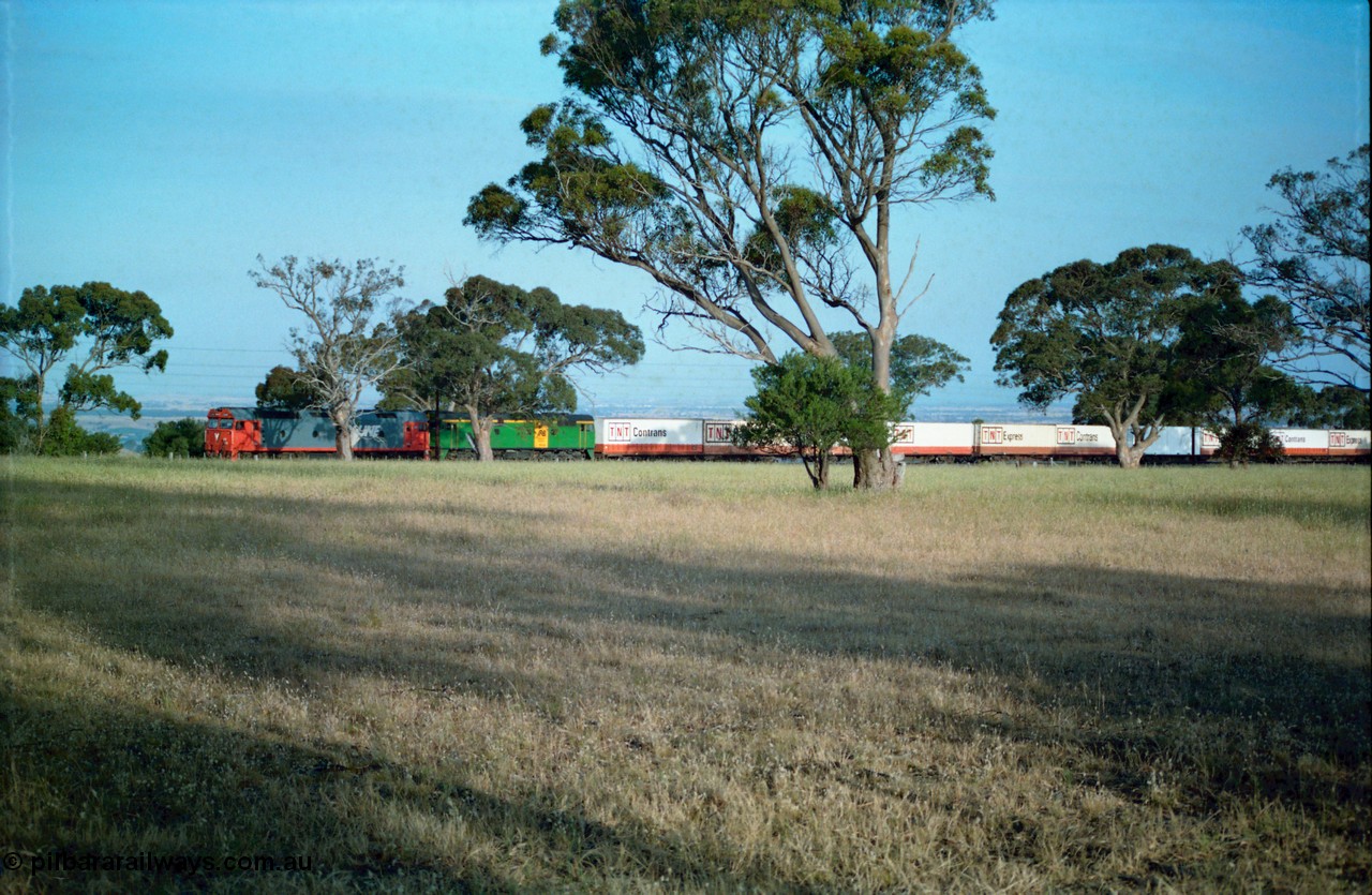 159-06
Bank Box Loop, down Adelaide bound broad gauge goods train hauled by V/Line G class G 540 Clyde Engineering EMD model JT26C-2SS serial 89-1273 and Australian National 700 class 704 AE Goodwin ALCo model DL500G serial G6059-2, expanded view with loaded TNT container waggons.
Keywords: G-class;G540;Clyde-Engineering-Somerton-Victoria;EMD;JT26C-2SS;89-1273;