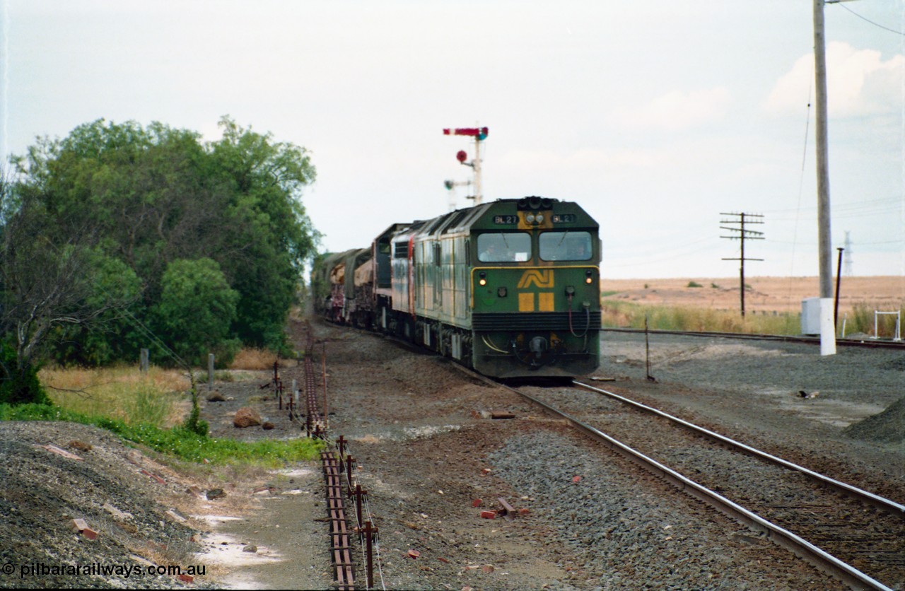 159-11
Gheringhap, track view looking east towards Geelong from the former No.2 platform, signal rodding running along edge of platform, Australian National broad gauge BL class BL 27 Clyde Engineering EMD model JT26C-2SS serial 83-1011 leads sister BL class and a V/Line S class and X class locomotives with down goods train 9169 as it arrives on their way to Adelaide.
Keywords: BL-class;BL27;Clyde-Engineering-Rosewater-SA;EMD;JT26C-2SS;83-1011;