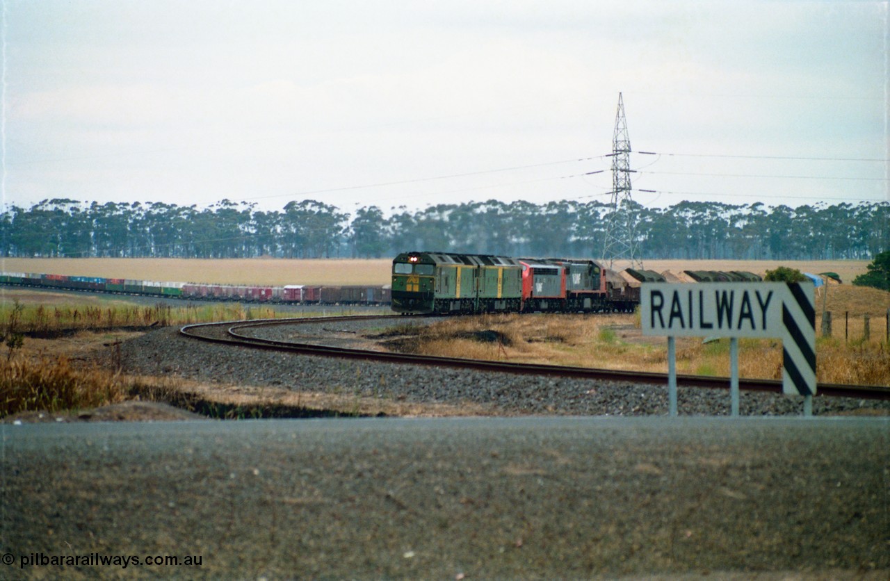 159-13
Lismore, distant view across Gnarpurt Road grade crossing of Australian National broad gauge BL class BL 27 Clyde Engineering EMD model JT26C-2SS serial 83-1011 leading a sister BL class and V/Line S and X class locomotives with down goods train 9169 as it runs round the curves on their way to Adelaide.
Keywords: BL-class;BL27;Clyde-Engineering-Rosewater-SA;EMD;JT26C-2SS;83-1011;
