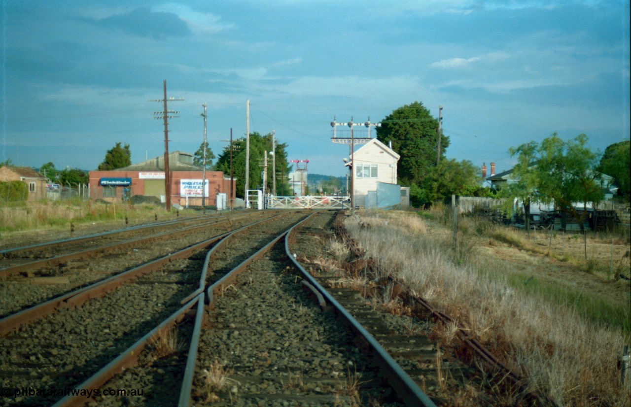 159-16
Ballarat D Signal Box, Linton Junction, broad gauge track view from the Cattle Yard Line looking east, Linton Line then the Ararat Line with the down crossover visible, triple doll semaphore signal 20 facing down train is visible behind the signal box, with the Gillies Street interlocked gates, staff exchange platform and up home semaphore signal post 19, points, track work and point rodding.
