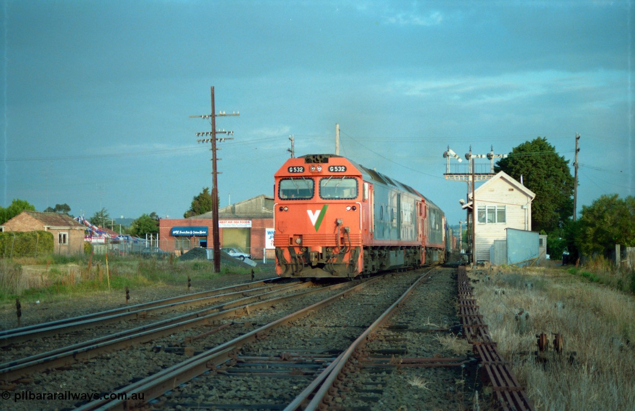 159-21
Ballarat D Signal Box, Linton Junction, V/Line broad gauge G class G 532 Clyde Engineering EMD model JT26C-2SS serial 88-1262 leads a sister with a down Adelaide bound goods train across Gillies Street triple doll semaphore signal post 20 is pulled off for the Ararat line as the train swings off the down line which becomes the Linton line, with the Cattle Yard line points just visible, points and track work, interlocking and point rodding.
Keywords: G-class;G532;Clyde-Engineering-Somerton-Victoria;EMD;JT26C-2SS;88-1262;