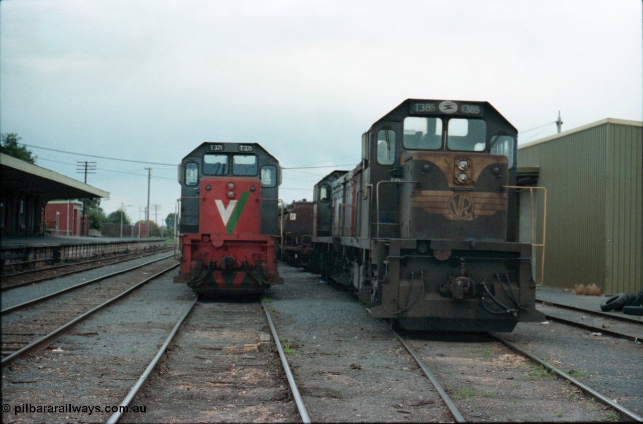 160-26
Shepparton, yard view of stabled broad gauge V/Line T class locomotives T 371 Clyde Engineering EMD model G8B serial 64-326 and T 385 serial 64-340 still in Victorian Railways blue and yellow livery, goods shed on the right, station platform and building on the left, T class T 393 serial 65-423 is behind T 385.
Keywords: T-class;T371;Clyde-Engineering-Granville-NSW;EMD;G8B;64-326;