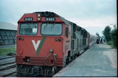 160-08
Murchison East, station platform view of down Cobram passenger train pausing for platform duties behind V/Line broad gauge N class locomotive N 465 'City of Ballaarat' Clyde Engineering EMD model JT22HC-2 serial 86-1194 with N set, super phosphate shed at left of image.
Keywords: N-class;N465;Clyde-Engineering-Somerton-Victoria;EMD;JT22HC-2;86-1194;