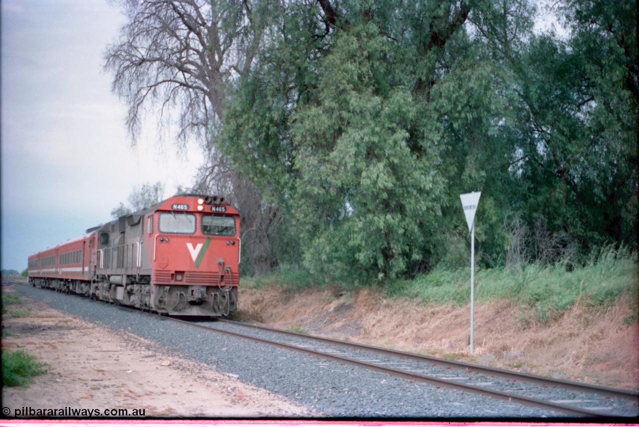 161-17
Yarroweyah, V/Line up broad gauge Cobram passenger train hauled by N class locomotive N 465 'City of Ballaarat' Clyde Engineering EMD model JT22HC-2 serial 86-1194 and N set past overgrown former station site, yard behind.
Keywords: N-class;N465;Clyde-Engineering-Somerton-Victoria;EMD;JT22HC-2;86-1194;