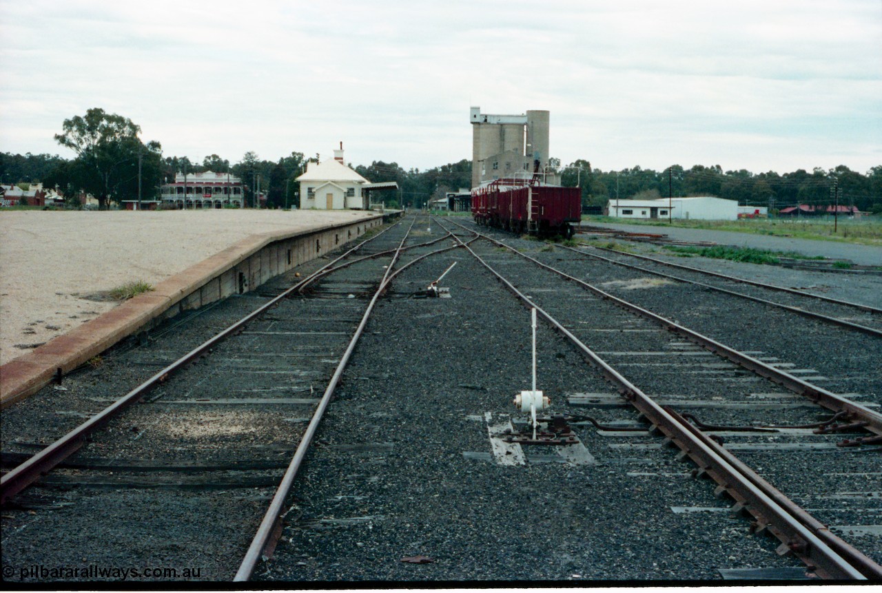 161-30
Tocumwal, broad gauge station yard overview looking south from end of platform, track and points and levers, station building and sleeper transport waggons, a hotel and flour mill in the background.
