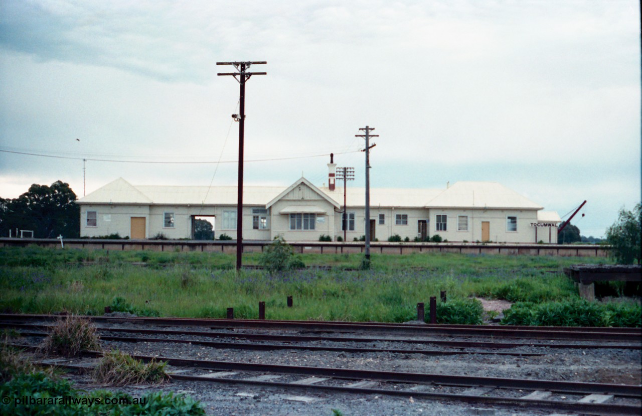 161-35
Tocumwal station building elevation from the dual gauge or NSWGR platform side, the tracks in front are broad gauge, while the ones in the middle between the post are standard gauge.
