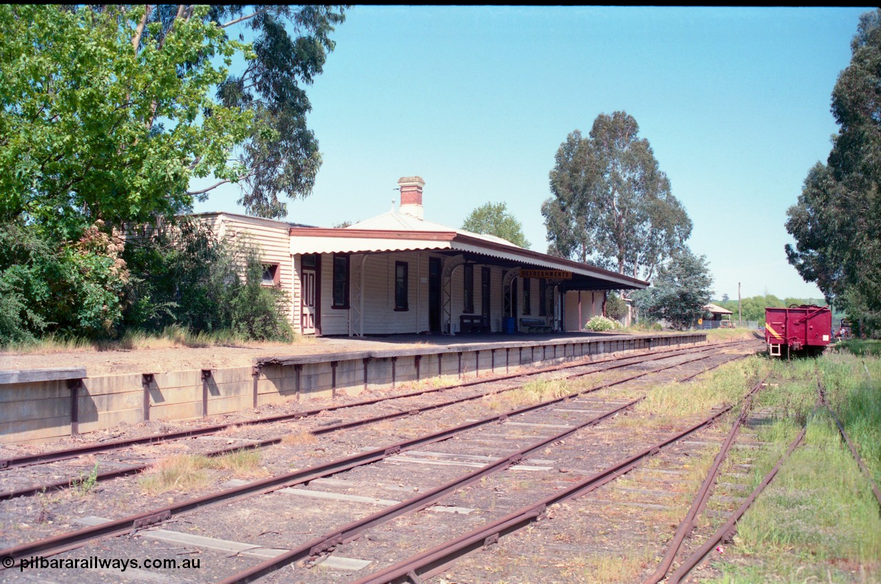 162-1-10
Healesville, station yard view looking south, station building and platform, yard overview, freshly repainted GY type four wheel waggon in yard.
