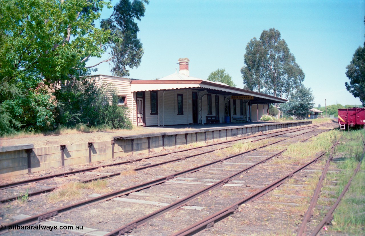 162-1-11
Healesville, station yard view looking south, station building and platform, yard overview, freshly repainted GY type four wheel waggon in yard.
